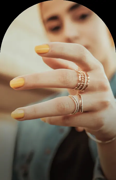Hand wearing stacked gold rings