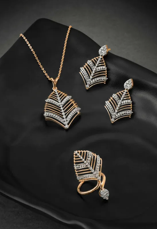 Gold necklace and earrings displayed on dark fabric